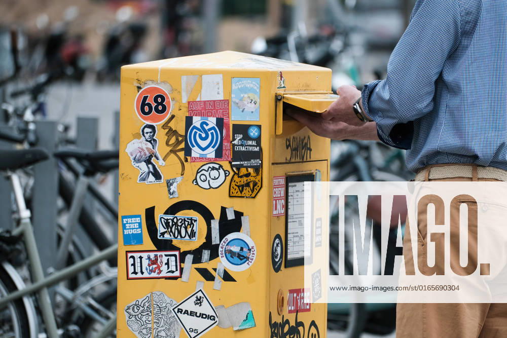 Dusseldorf 15 08 2022 mailbox yellow post letter letters DHL snailmail email letter post horn retro sticker pasted vandalism letter delivery letter election Dusseldorf North Rhine Westphalia Germany