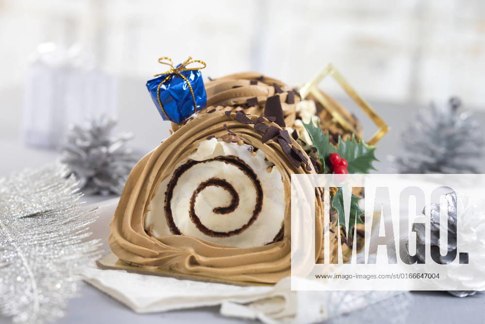 A yule log cake, traditional of christmas time , 19281670.jpg, Christmas, Shiny, Tradition, bright, buche, cake, celebrate, celebration, chocolate, coffe cream, confection, confectionery, cuisine, culinary, de, dessert, eating, festive, food, french, garland, gastronomy, genoise, golden, gourmet, horizontal, log, meal, new year, new years occasion, noel, ornament, ornamented, party, pastry, roll, season, seasonal, sponge, sweet, swiss, tinsel, traditional, typical, yule,