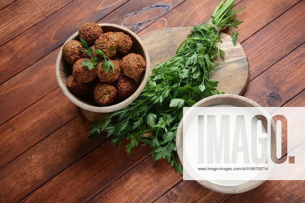 Falafel balls with parsley in wooden bowl with tahini sauce. Vegan healthy food, Falafel balls with parsley in wooden bowl with tahini sauce. Vegan healthy food, Falafel balls with parsley in wooden bowl with tahini sauce. Vegan healthy food, 08.04.2021,