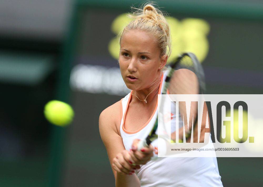 Paula Kania of Poland hits a return during their women s singles tennis match at the Wimbledon Tennis Championships, in London, the United Kingdom, June 23, 2014. (Xinhua MengxYongmin) (SP)UK-LONDON-TENNIS-WIMBLEDON