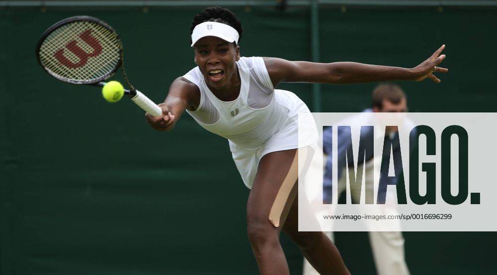 American Venus Williams returns in her match on day one of the 2014 Wimbledon Championships in London on June 23, 2014. LON2014062315