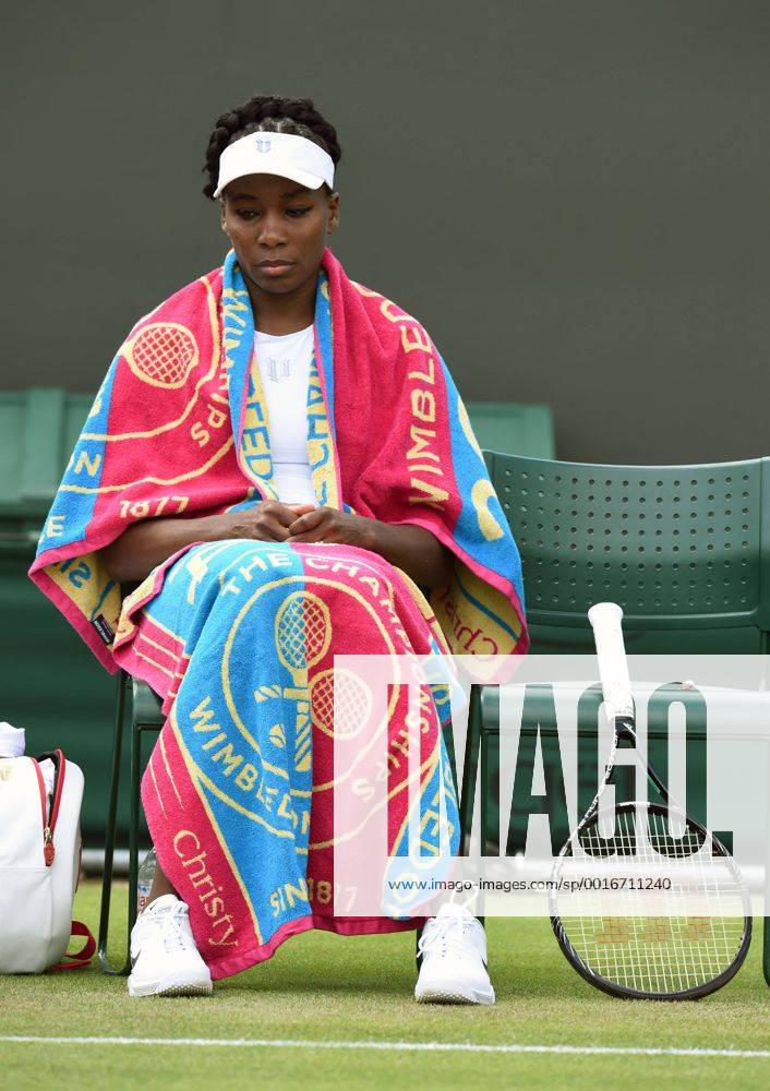 Venus Williams wraps up in Wimbledon towels while Kurumi Nara receives medical treatment on Court 3.