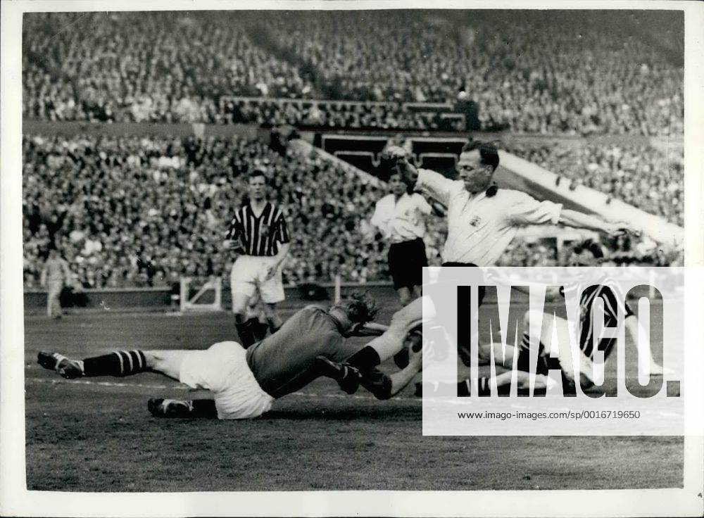 Manchester City wins the F.A. Cup. Photo shows Manchester City goalkeeper, Bert Trautmann, dives at the feet of the Birmingham City inside-right, Peter Murphy during the F.A. Cup Final at London, Wembley today. Trautmann, who was recently elected Footballer of the Year , was given a great ovation by the huge crowd, after the match. During the closing stages of the game he sustained a neck injury, which unsteadied him for a while, but he still carried on playing. Manchester City won by 3-1. - ZUMAk09