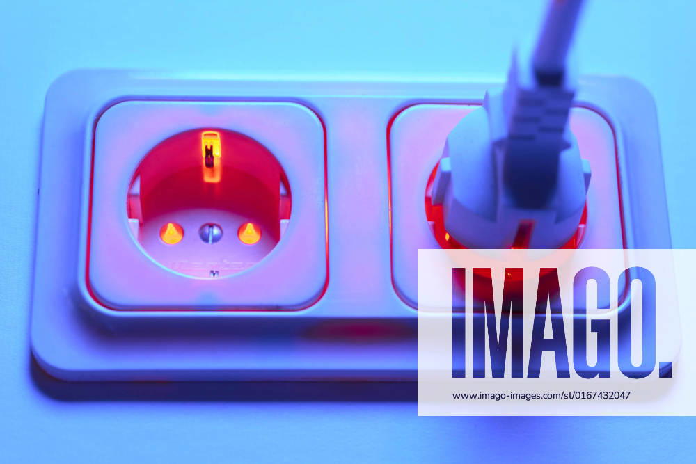 Threat of overloading the power grid in winter by connecting too many fan heaters Red lighted socket with Schuko plug Energy prices electricity, Bonn, Germany on 28 08 2022