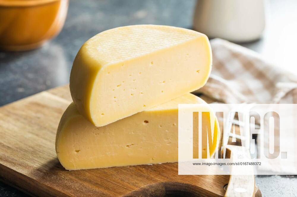 Block of hard cheese., Block of hard cheese on cutting board., Block of hard cheese on cutting board., 15.10.2021,