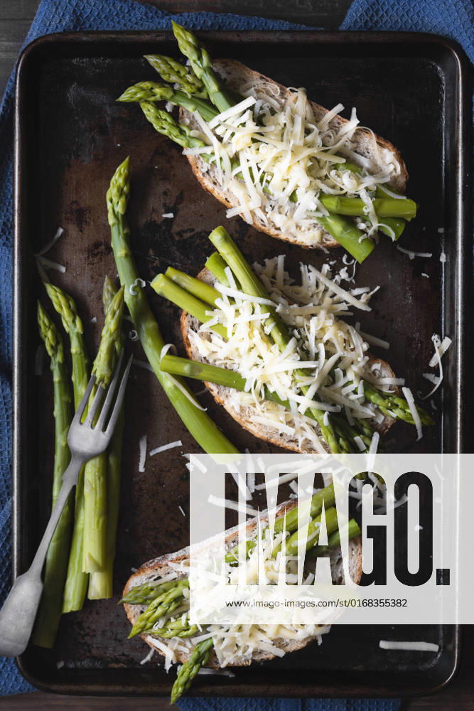 Preparation of cheese and asparagus on sourdough bread.