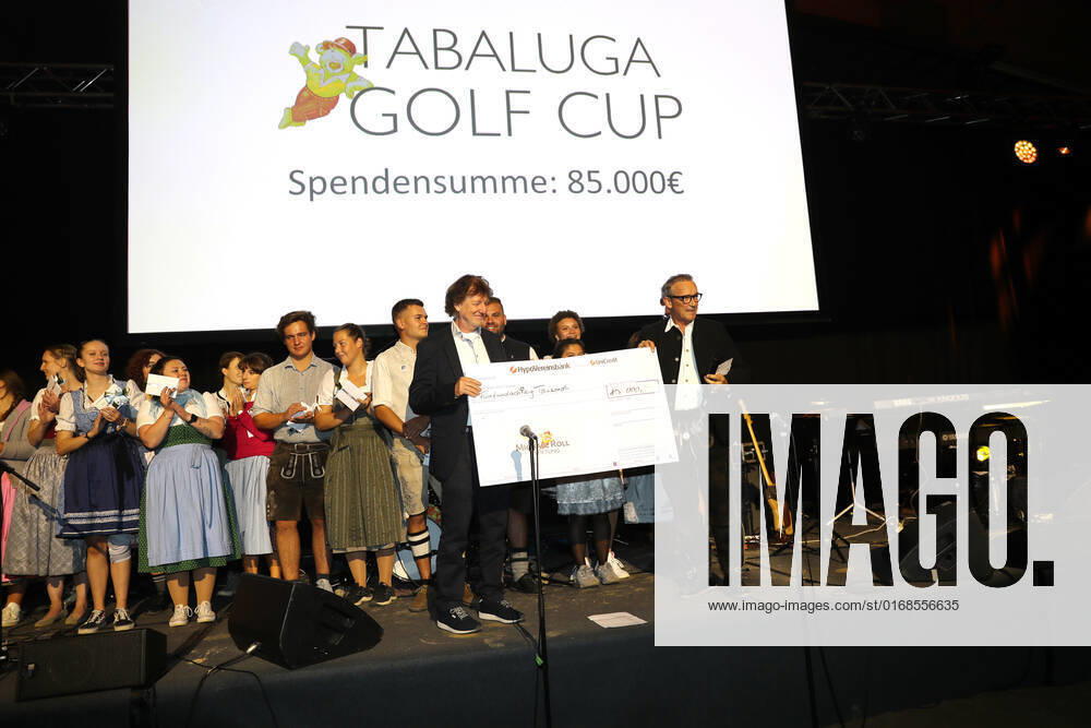 28 Tabaluga Golf Cup Michael Roll and his wife Claudia present the head of the Tabaluga Foundation Dr Jürgen Haerlin with a donation check for 90 000 Euro, Tutzing Bavaria Germany Golf Course Tutzing