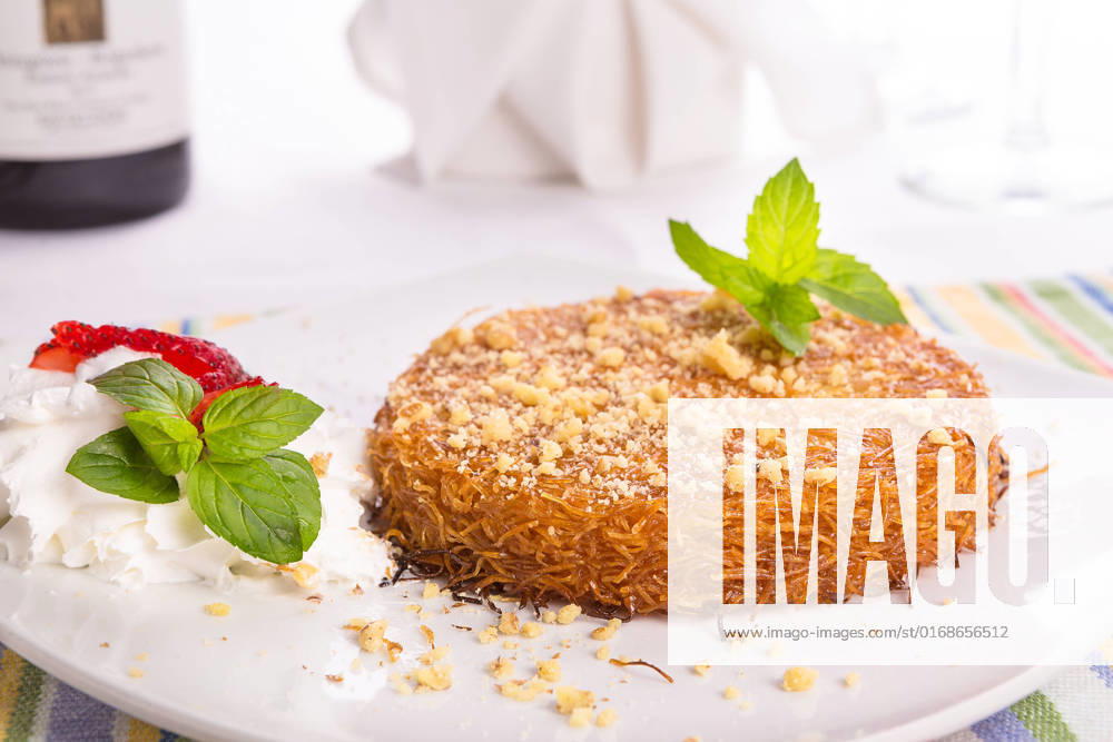 IMAGO Creative, Food, Künefe Turkish dessert kunefe with mint leaves, slices strawberry on a full fat cream and pinch of walnuts served after a nice meal , 10224680.jpg, Food, Industry, Plate, appetizing, baked, baklava, calorie, carbohydrates, close, confectionery, cream, cuisine, delicious, dessert, dinner, dressing, east, exotic, fat, full, gourmet, honey, hot, istanbul, kadayif, kanafeh, kunafah, kunafeh, kunefe, leaves, luxury, mediterranean, mint, napkin, nutritious, pastry, restaurant, still, strawberry, sugar, sugary, sweet, syrup, taste, tasty, traditional, turkish, walnut, wine, yummy,