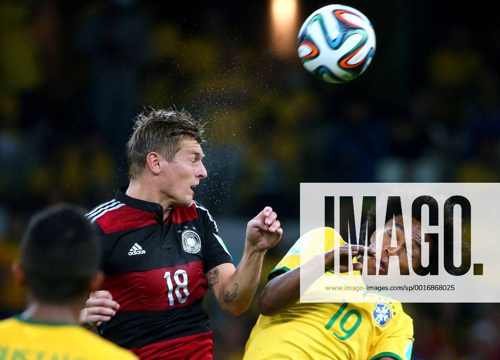 ITAR-TASS: BELO HORIZONTE, BRAZIL. JULY 8, 2014. Germany s Toni Kroos (C) and Brazil s Willian fight for the ball in their 2014 FIFA World Cup semifinal match at Mineirao Stadium. Germany won the game 7:1. RE149AD1