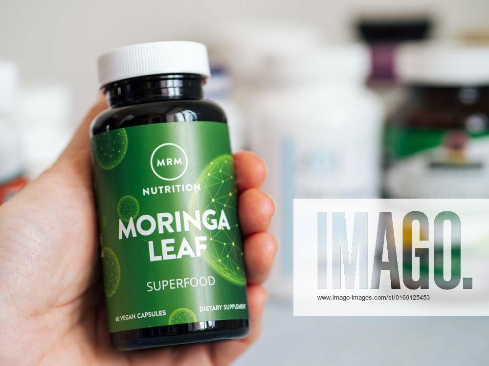 Jar with Moringa Leaf capsules in female hand, Moscow, Russia - March 09, 2021: Jar with Moringa Leaf capsules by MRM in female hand and others nutrition supplements in blurred background. Moringa is raw superfood from india ancient miracle tree., Moscow, Russia - March 09, 2021: Jar with Moringa Leaf capsules by MRM in female hand and others nutrition supplements in blurred background. Moringa is raw superfood from india ancient miracle tree., 30.01.2022,