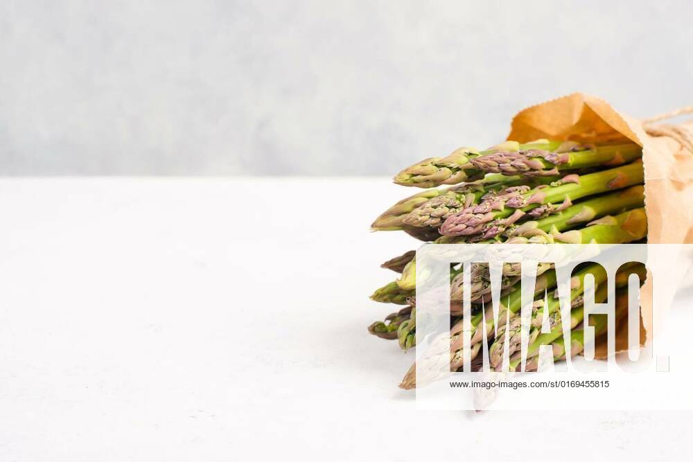 Fresh green bundle of asparagus on a white textured table, vegetables in spring, gourmet cuisine food, cooking a vegan meal, Fresh green bundle of asparagus on a white textured table, vegetables in spring, gourmet cuisine food, cooking a vegan meal, Fresh green bundle of asparagus on a white textured table, vegetables in spring, gourmet cuisine food, cooking a vegan meal, 30.05.2022,