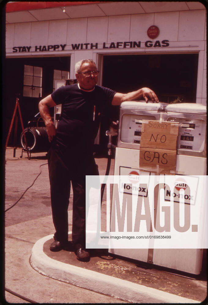 Gas station operator stands by empty gas pump during the height of the gas shortage, no location, 1973. 1063_05_Gas_Station_Operator_Stands_by_Empty_Pumps