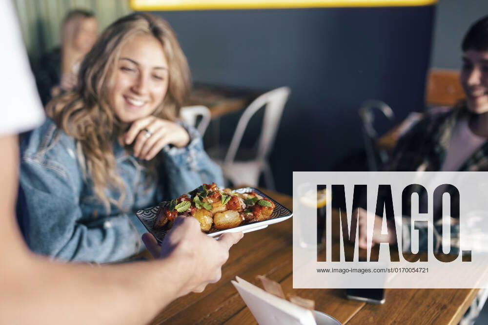 Hand of waiter serving food to lesbian customers in restaurant model released, Symbolfoto property released, JSRF02201
