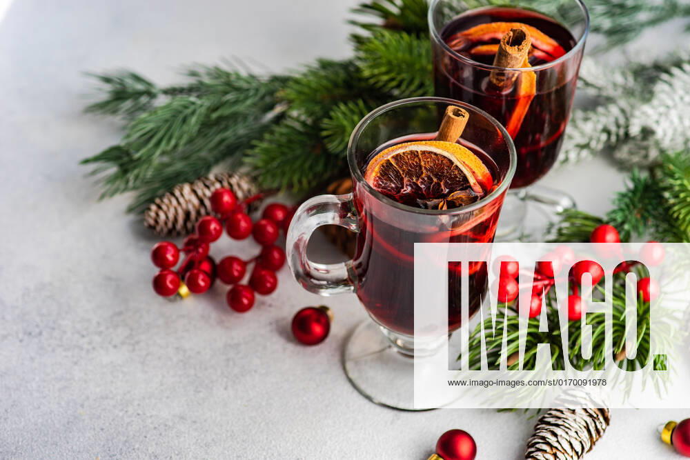 Mulled wine with spices with holiday decoration on white concrete background AnnaBogush_ID867_31932_002