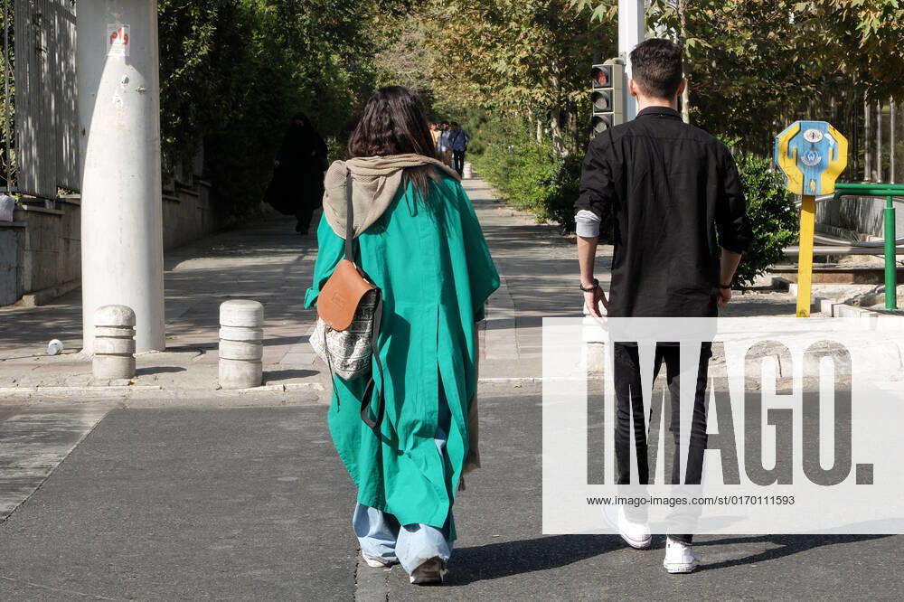 An Iranian couple walks in a street, in Tehran, Iran, 28 September 2022. Iran has been facing many anti-government protests following the death of Masha Amini, a 22-year-old girl, who was detained on 13 September by the police unit responsible for enforcing Iran s strict dress code for women. Amini was declared dead on 16 September, after she spent 3 days in a coma. Protests first broke out in Saqez, the hometown of Amini, during her funeral on 17 September. Tehran Iran - ZUMAi98_ 20220928_zih_i98_030