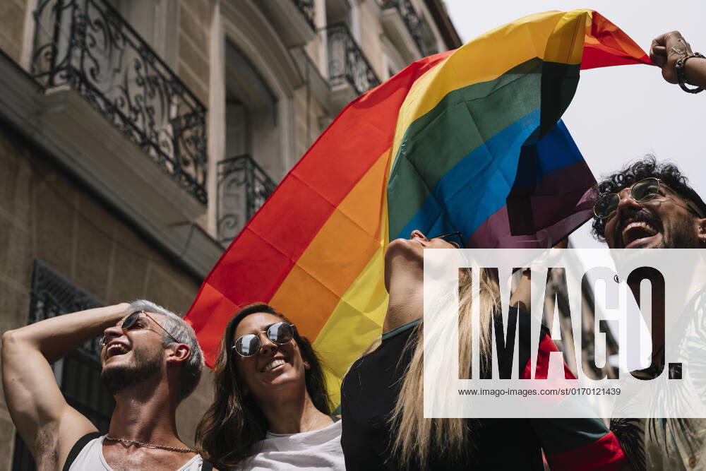 Group of friends with a flag of gay pride in the city of Madrid JoseLuisCarrascosa_GayPride_10