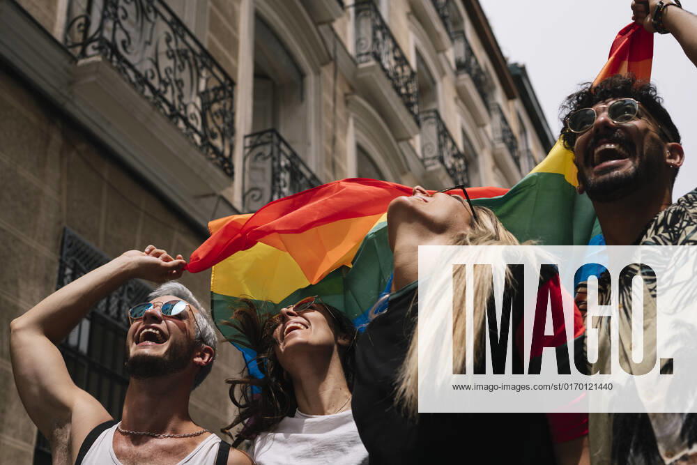 Group of friends with a flag of gay pride in the city of Madrid JoseLuisCarrascosa_GayPride_11