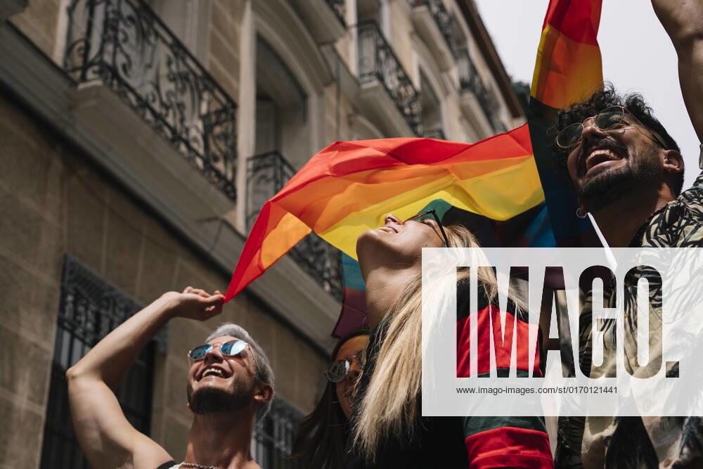 Group of friends with a flag of gay pride in the city of Madrid JoseLuisCarrascosa_GayPride_12