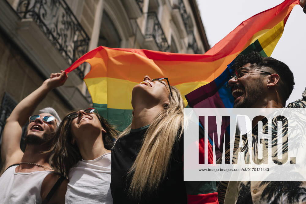 Group of friends with a flag of gay pride in the city of Madrid JoseLuisCarrascosa_GayPride_14