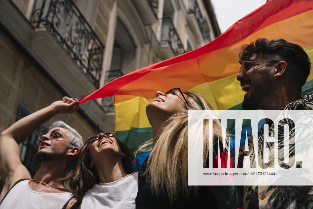 Group of friends with a flag of gay pride in the city of Madrid JoseLuisCarrascosa_GayPride_15