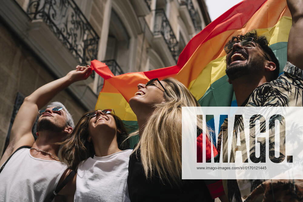 Group of friends with a flag of gay pride in the city of Madrid JoseLuisCarrascosa_GayPride_16