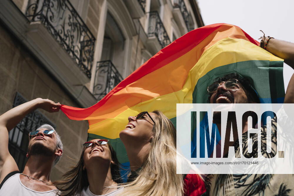 Group of friends with a flag of gay pride in the city of Madrid JoseLuisCarrascosa_GayPride_17