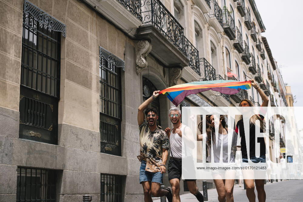 Group of friends with a flag of gay pride in the city of Madrid JoseLuisCarrascosa_GayPride_6