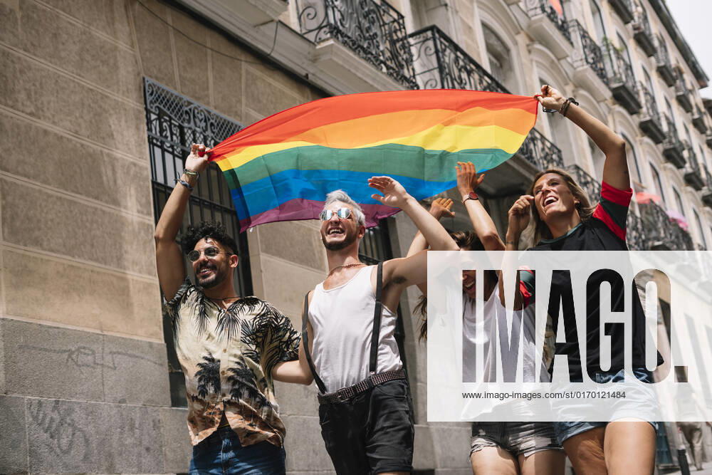 Group of friends with a flag of gay pride in the city of Madrid JoseLuisCarrascosa_GayPride_7