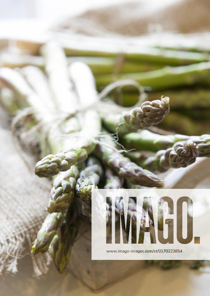 Freshly picked asparagus on a rustic tray