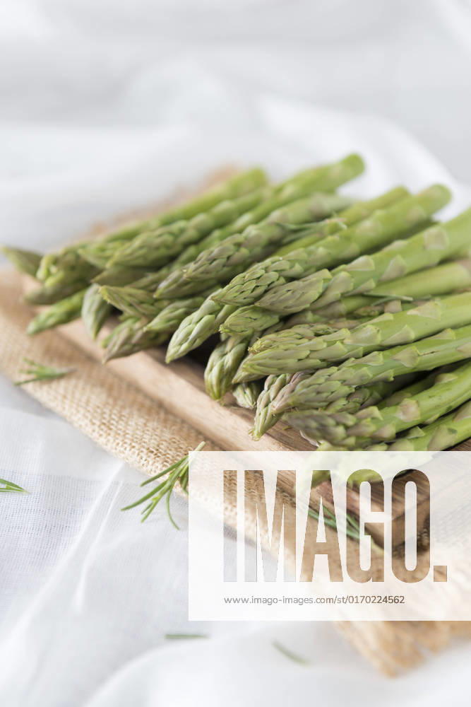 Asparagus spears on a chopping board.