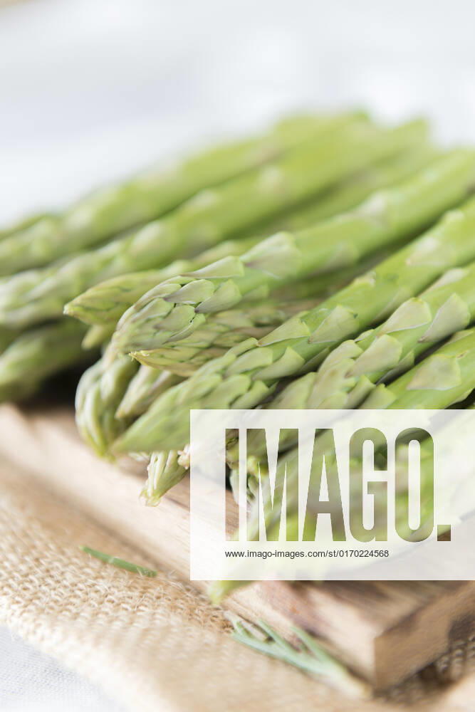 Asparagus spears on a chopping board.