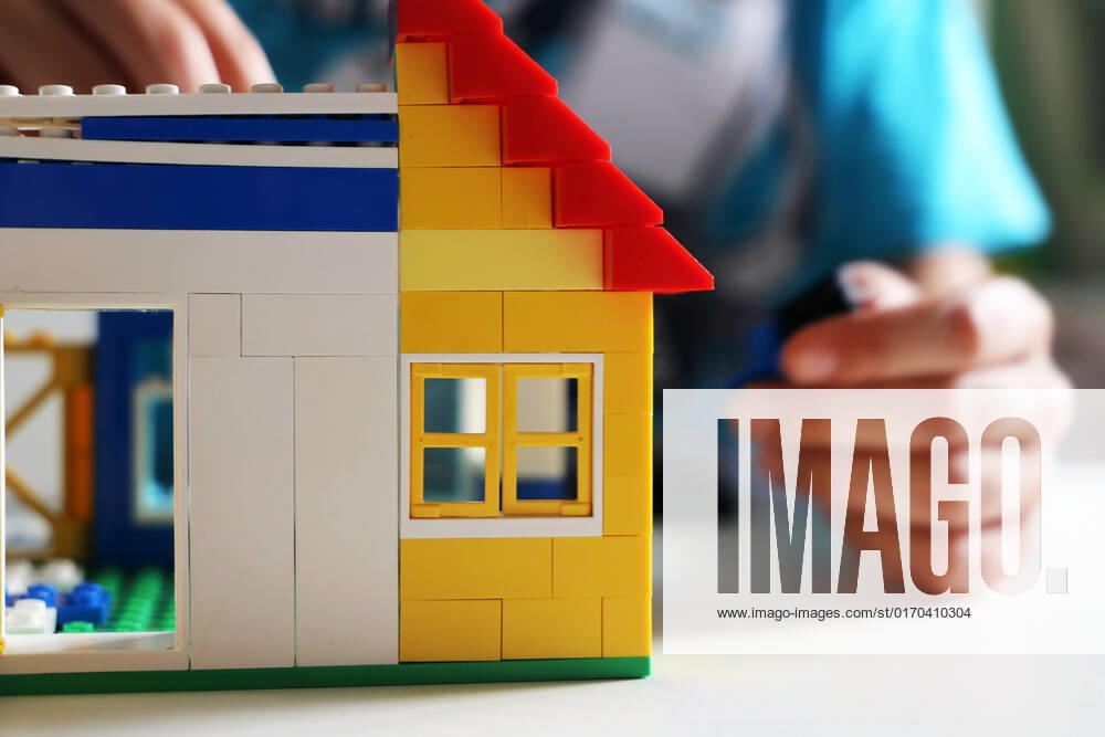 Boy builds with building blocks a house model released