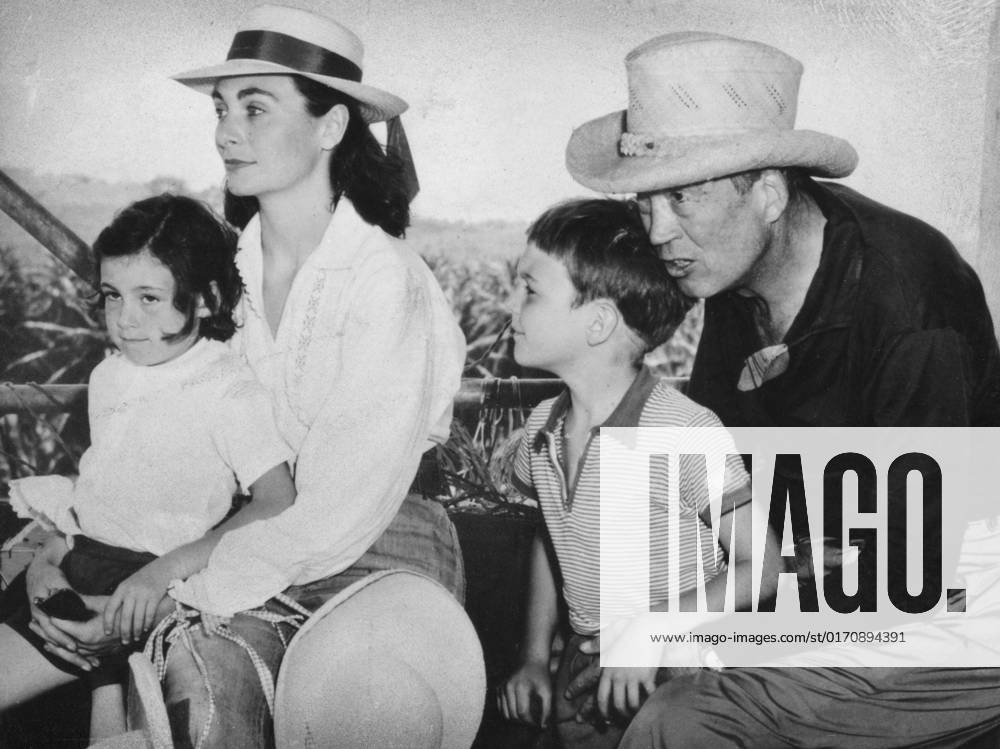 John Huston (1906-1987), American film director and actor, 1957. Huston is seen here with his wife Ricki Soma, daughter Angelica and son Tony (possibly during the filming of Heaven Knows, Mr. Allison). John Huston (1906-1987), American film director and actor, 1957. Artist: Unknown