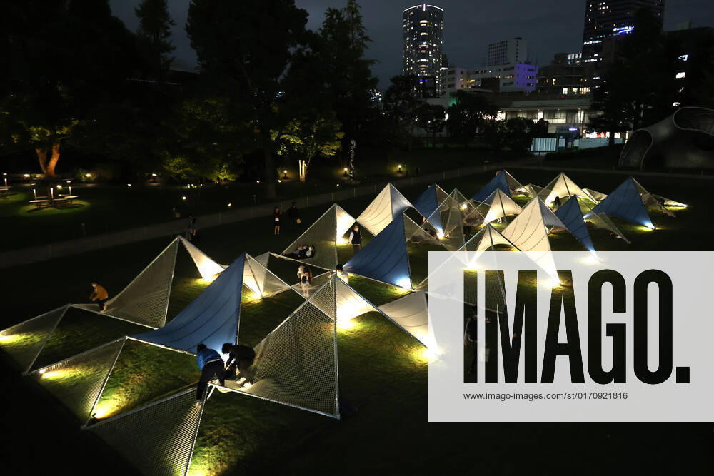 Tokyo, Japan - A large installation Sea Hammock formed by tarps and fishnets created by Japanese architect Yuko Nagayama is displayed on the lawn field as a part of the Tokyo Midtown Design Touch 2022 in Tokyo on Friday, October 14, 2022. An annual design event with the theme of Design for Sustainable Future started at the Tokyo Midtown through November 3. , aflo_201255367.jpg,