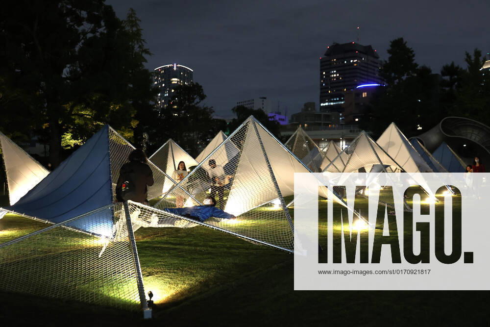 Tokyo, Japan - A large installation Sea Hammock formed by tarps and fishnets created by Japanese architect Yuko Nagayama is displayed on the lawn field as a part of the Tokyo Midtown Design Touch 2022 in Tokyo on Friday, October 14, 2022. An annual design event with the theme of Design for Sustainable Future started at the Tokyo Midtown through November 3. , aflo_201255368.jpg,