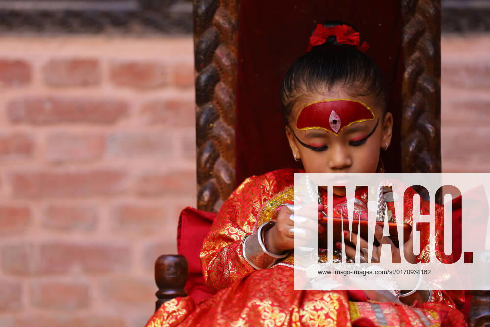 Nepal s Living Goddess-Kumari of Bungmati Yubika Bajracharya, newly anointed Living Goddess- Kumari of Bungmati, a town in the outskirts of Lalitpur District of Nepal watchs cartoon over her cell-phone as she sits on her throne to give blessing to public. Nepal has a unique tradition of appointing and worshipping pre-pubescent girls as re-incarnation of Goddess Taleju Bhawani. Every town in Nepal which has a temple of Taleju Bhawani has a girl as Living Goddess Kumari who is worshipped and revered by all. The Kumari of Kathmandu s Basantapur Durbar Square is considered the Royal one who is barely taken out of her residence. Lalitpur Bagmati Nepal