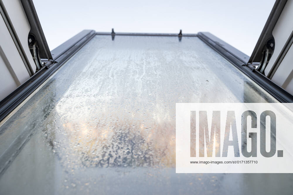 Germany, Bavaria - 31 October 2022: Fogged skylight in the morning. Water drops from condensation on a window
