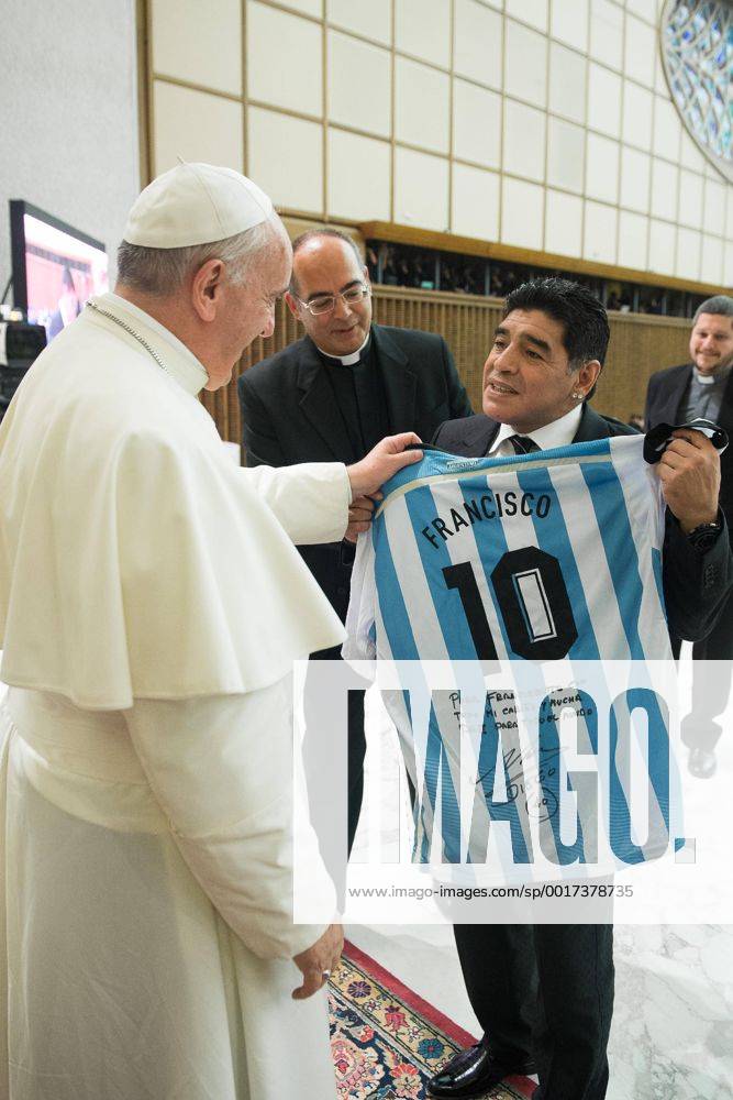 Diego Armando Maradona presents Pope Francis with an Argentine national soccer team jersey bearing the name Francisco, in the Paul VI hall at the Vatican.