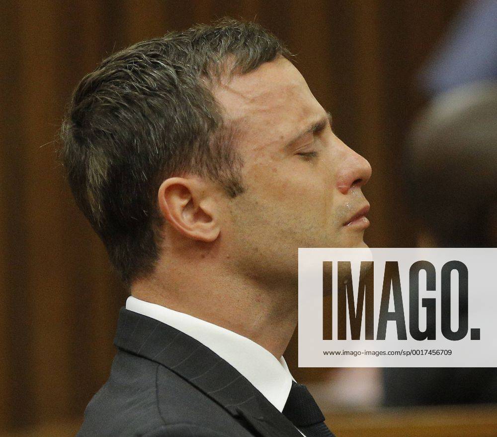 BY COURT ORDER, THIS IMAGE IS FREE TO USE. PRETORIA, SOUTH AFRICA - SEPTEMBER 11: Oscar Pistorius cries while seated in the dock during the verdict in his murder trial at the Pretoria High Court on September 11, 2014, in Pretoria, South Africa. Pistorius, stands accused of the murder of his girlfriend, Reeva Steenkamp, on February 14, 2013. This is his official trial, the result of which will determine the paralympian athlete s fate. Judge Masipa has began delivering her verdict. Oscar Pistorius Murder Trial XKL17