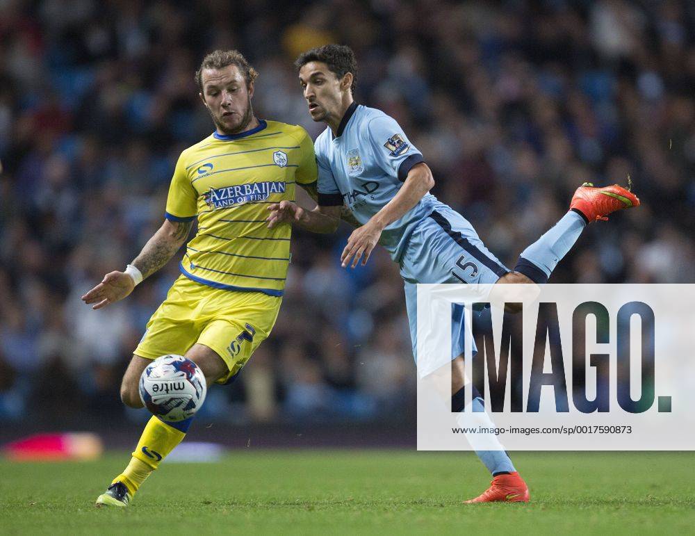 Wednesday s Stevie May and Jesus Navas of Manchester City - Manchester City vs. Sheffield Wednesday - Capital One League Cup - Anfield - Liverpool - 24 09 2014 .