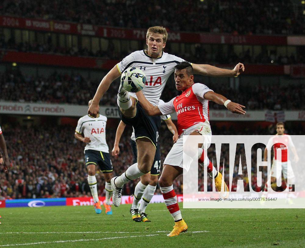 Arsenal s Alexis Sanchez tussles with Tottenham s Eric Dier - Barclays Premier League - Arsenal vs Tottenham Hotspur - Emirates Stadium - England - 27th September 2014 - .
