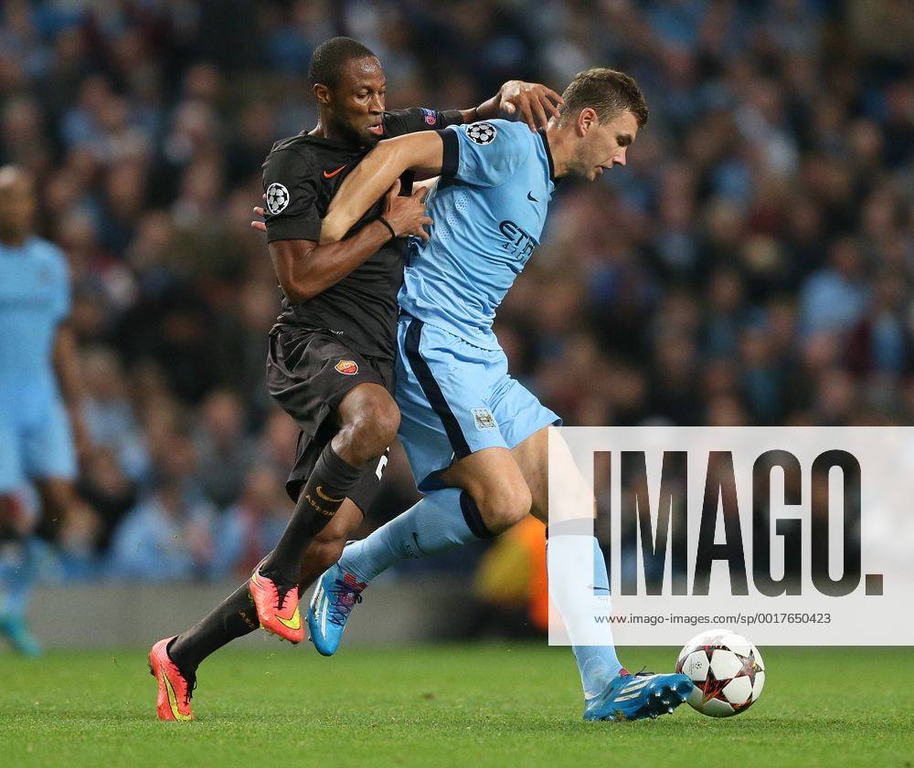 Seydou Keita of Roma challenges Edin Dzeko of Manchester City - UEFA Champions League group E - Manchester City vs Roma - Etihad Stadium - Manchester - England - 30th September 2014 - Picture Simon Bellis Sportimage .