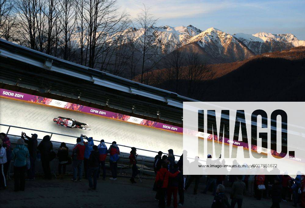 Sochi, Russia - CHRISTIAN NICCUM and JAYSON TERDIMAN of the USA, cruises around a turn to an 11th place finish in Men s Luge Doubles, as the sun sets on the Caucasus Mountains at the Sanki Sliding Center at the 2014 Sochi Winter Olympics. Rocky Mountain High - ZUMASoch