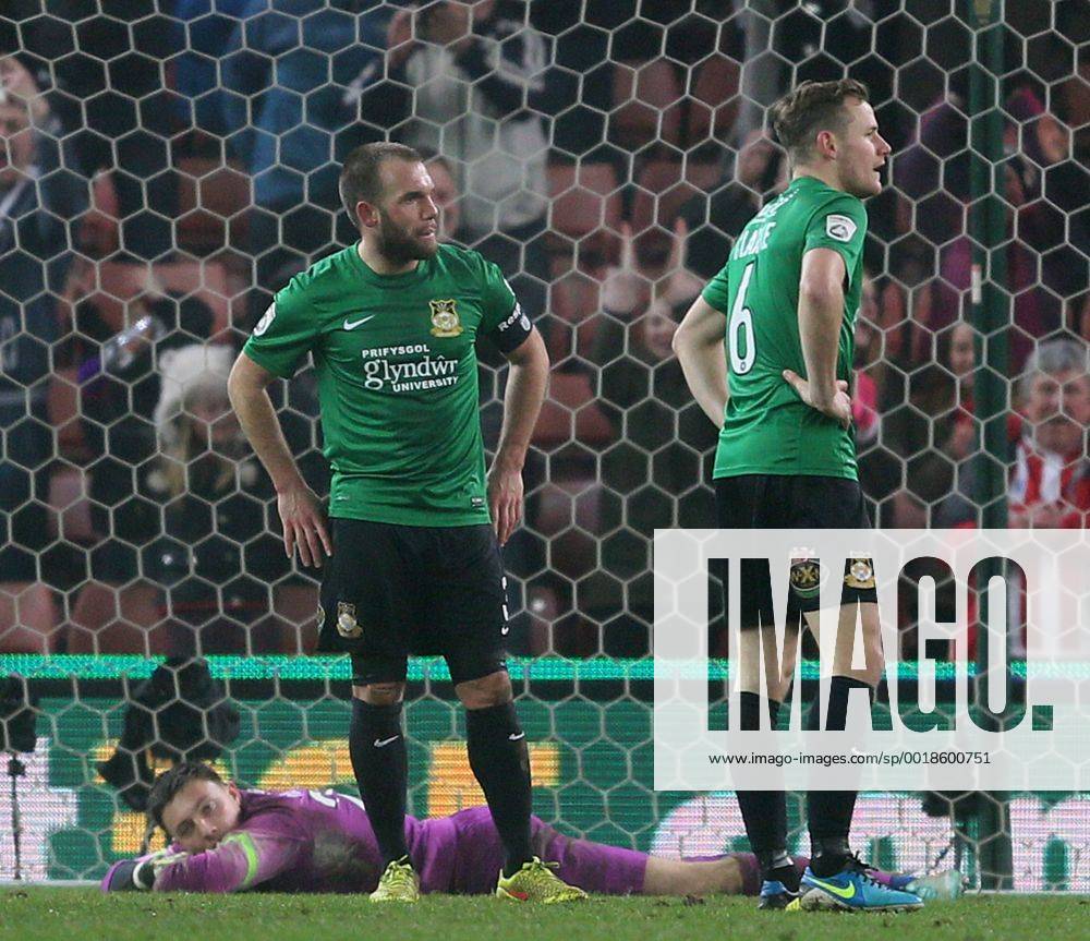 Jon Platt, Neil Ashton and Joe Clarke of Wrexham dejected as Stoke players celebrate- FA Cup Third Round - Stoke City vs Wrexham - Britannia Stadium - Stoke on Trent - England - 4th January 2015 - Picture Simon Bellis Sportimage .