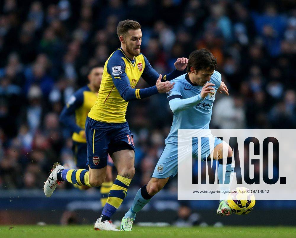 Aaron Ramsey of Arsenal tackles David Silva of Manchester City - Barclays Premier League - Manchester City vs Arsenal - Etihad Stadium - Manchester - England - 18th January 2015 - Picture Simon Bellis Sportimage .