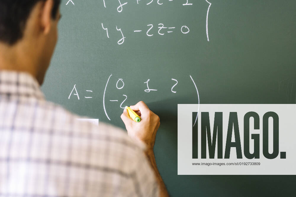 Math teacher solving problems on chalkboard model released, Symbolfoto, DAMF01093
