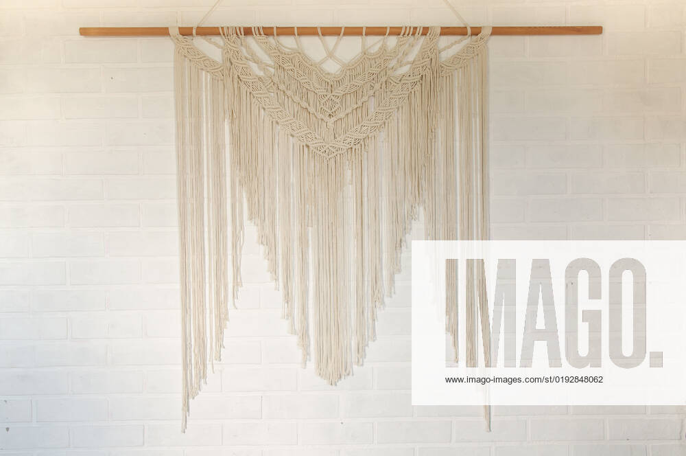 Beige reed against a white wall with a macrame wall panel. A minimal, stylish, trendy concept with a beautiful background with light neutral colors. , 35135516.jpg, art, background, beige, beige background, bohemian, boho, cozy, craft, decor, decoration, decorative, design, eco, female, floral, flower, hand, handmade, hobby, home, house, interior, knit, knot, lifestyle, living, macrame, macramo , minimalism, ornament, pastel, pattern, plant, room, rope, rustic, scandinavian, still, style, table, texture, tradition, traditional, vintage, wall, wall art, wall hanging, wall hangings, white, yellow