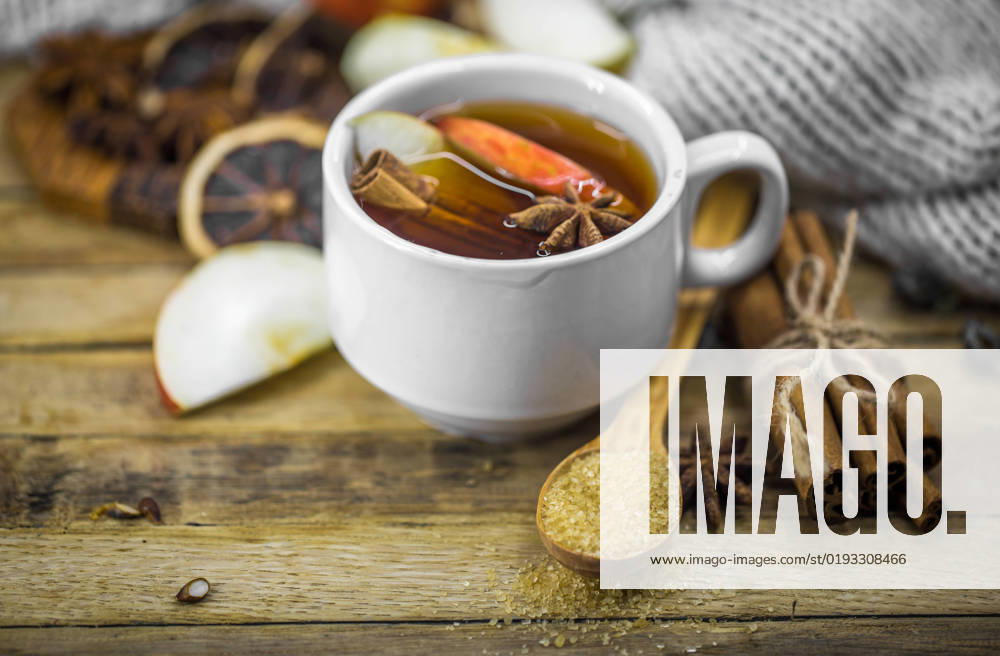 A Cup of hot tea with a cinnamon stick and a spoonful of brown sugar on wooden background, holiday concept and warm mood , 36069146.jpg, tea, cinnamon, drink, cup, hot, glass, decoration, red, aroma, anise, aromatic, christmas, season, sticks, winter, beverage, wooden, food, closeup, nobody, spice, brown, teacup, holiday, background, warm, mulled, slice, delicious, punch, spiced, xmas, traditional, taste, fruit, sweet, life, still, close, seasoning, wine, clove, nutmeg, pine cone, seasonal, wintry, orange, pinecone, alcohol, spices