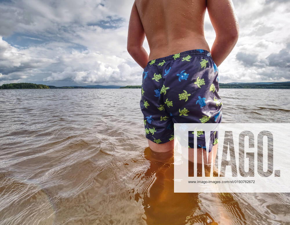 Little joyful Caucasian funny boy try cold water of lake. Kid stay in water with level at knee, model released, , 36931044.jpg, boy, caucasian, cheer, child, childhood, cold water, cold weather, cooling, cowards, droplet, dynamic, enthusiasm, expression, floundering, happiness, hard, holiday, hot, joy, kid, knee, lad, lake, laughing, lonely, low angle view, low view, natural, play, pond, poor, rest, river, sand, scenic, seashore, smile, son, splash, summer, summertime, sunbeam, swim, swimmer, swimming pants, swimming shorts, swimming suit, try, vitality, water