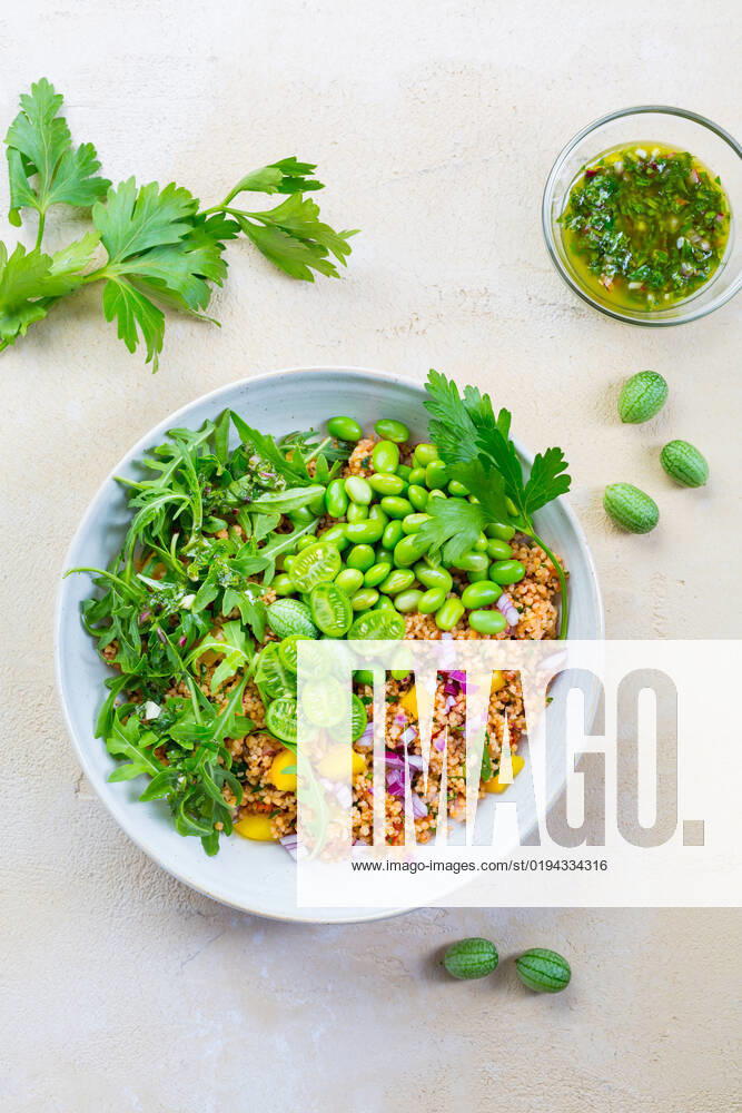 Healthy couscous salad with edamame beans Healthy couscous salad with edamame beans, rucola and cucamelon (Mexican miniature watermelon), with lemon and herbs dressing